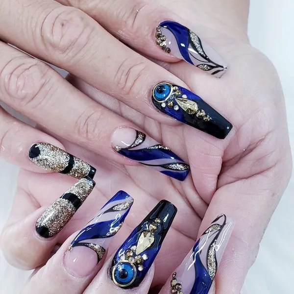 Navy and gold hand-painted nail art
