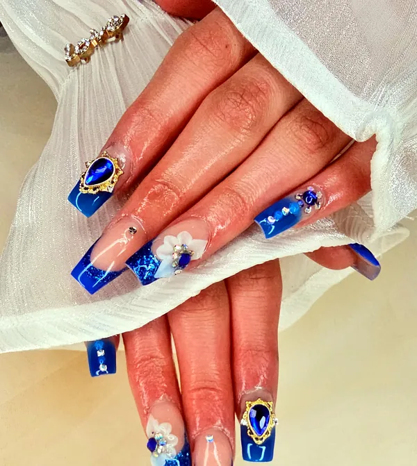 Royal blue coffin nails with glitter, crystals and 3D white flowers