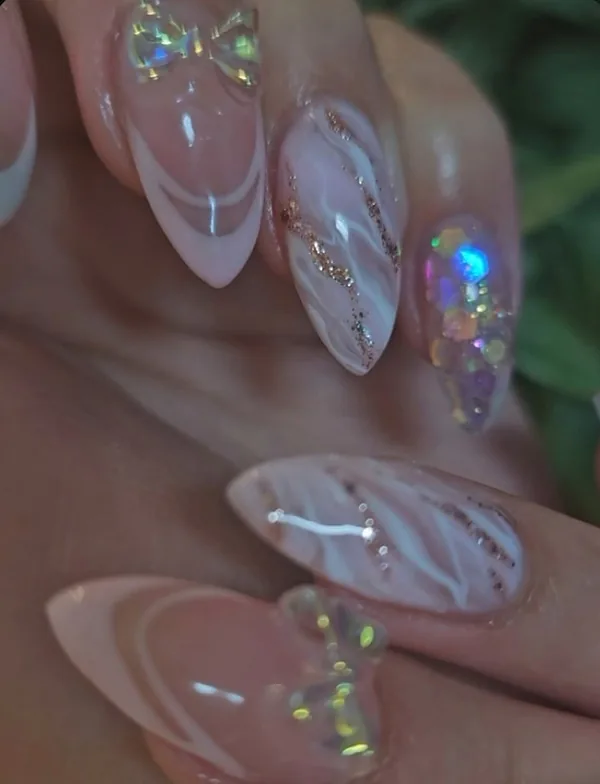 Clear almond nails with crystal 3D bows, white marble and gold flakes