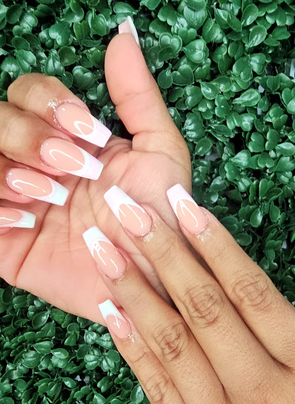 Long coffin nails with a soft pink and white French finish