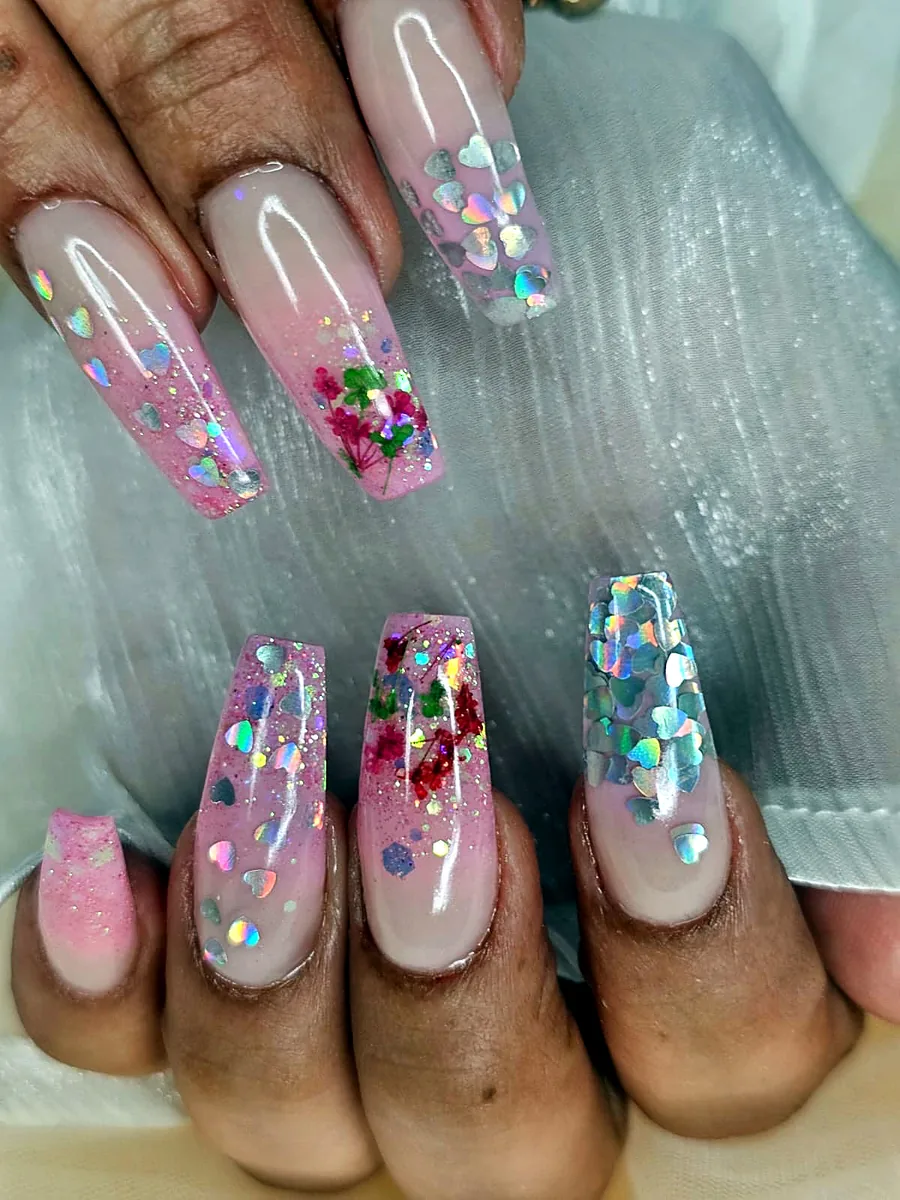 Long pink coffin nails with holographic hearts and real dried flowers