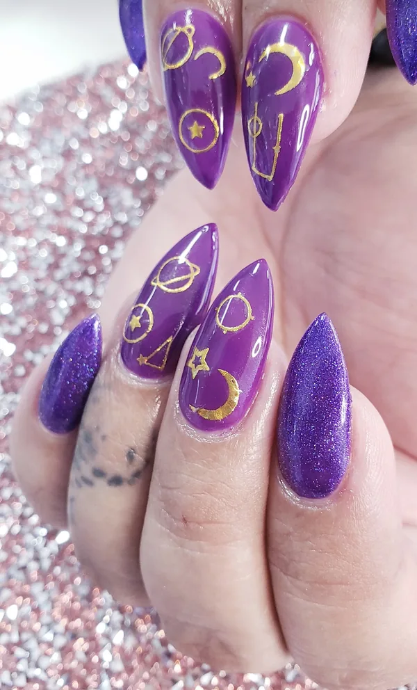 Purple glitter stiletto nails with gold moons